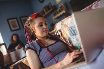 Visão de baixo ângulo da mulher hipster usando laptop em casa — Fotografia de Stock