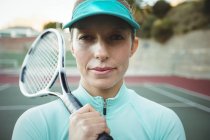 Теннисистка, стоящая на корте с теннисной ракеткой — стоковое фото
