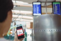 Passagierin benutzt Handy im Flughafen-Terminal — Stockfoto