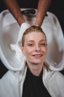 Hair stylist drying woman hair with towel in salon — Stock Photo