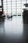 Empty airport waiting room with bright window — Stock Photo