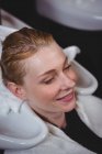 Hair stylist drying woman hair with towel in salon — Stock Photo