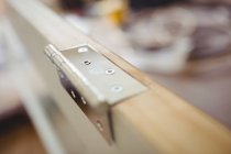 Close up of hinges on wooden door — Stock Photo