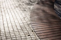 Close-up of boardwalk next to a pavement in town — Stock Photo