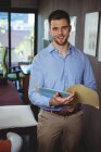 Portrait of male physiotherapist holding file in clinic — Stock Photo
