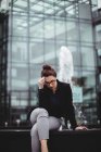 Tensed businesswoman outside office building — Stock Photo