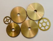 Collection of various gears on white paper in workshop — Stock Photo