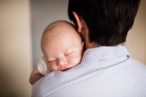 Rear view of Mother holding son at home — Stock Photo