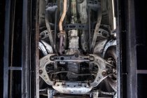 Close-up of car engine and components at repair garage — Stock Photo