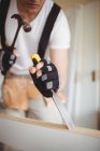 Cropped image of Carpenter working on wooden door at home — Stock Photo
