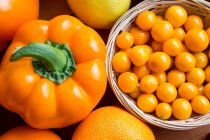 Top view of cherry tomatoes, bell pepper and oranges in supermarket — Stock Photo