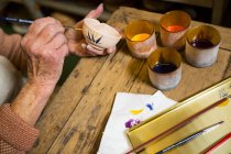 Imagem cortada de pintura de oleiro na tigela em oficina de cerâmica — Fotografia de Stock