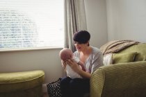 Mother playing with son in living room at home — Stock Photo