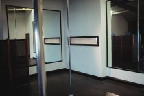 Vertical poles in empty fitness studio — Stock Photo