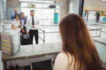 Passageiros esperando em fila no balcão de check-in no terminal do aeroporto — Fotografia de Stock
