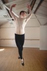 Ballerino saute tout en pratiquant la danse de ballet en studio — Photo de stock