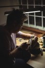 Nahaufnahme einer Handwerkerin, die in einer Werkstatt arbeitet — Stockfoto