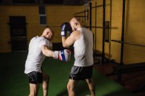 Side view of two thai boxers practicing boxing in gym — Stock Photo