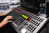 Hand of female student using sound mixer keyboard in a studio — Stock Photo