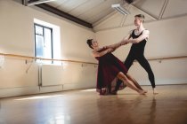 Ballet partners dancing together in modern studio — Stock Photo
