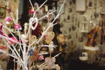 Diverses décorations en forme de coeur accrochées à une fausse branche dans un magasin d'antiquités — Photo de stock
