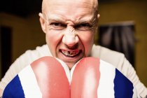 Close up of angry Boxer practicing boxing in fitness studio — Stock Photo