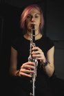 Portrait of woman playing a clarinet in music school — Stock Photo