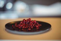 Fresh pomegranate seeds on the plate — Stock Photo