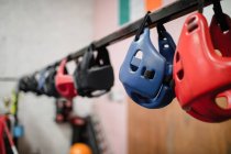 Close up of various headgears hanging in fitness studio — Stock Photo
