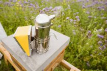 Close-up of bee smoker on beehive in field — Stock Photo