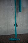 Hanging blue gymnastic fabric rope in fitness studio — Stock Photo