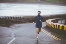 Atleta correndo na estrada durante o dia — Fotografia de Stock