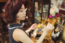 Стильна жінка вибирає чашку в антикварних магазинах — стокове фото
