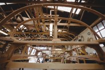 Wooden boat under construction in boatyard interior — Stock Photo