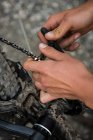 Male cyclist repairing his bicycle in forest on a sunny day — Stock Photo