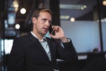 Business man talking on the mobile phone in office — Stock Photo