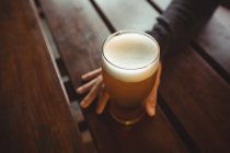Чоловік тримає келих пива в барі — стокове фото