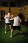 Two kick boxers fighting in gym — Stock Photo