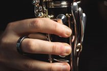 Close-up of woman playing a clarinet in music school — Stock Photo