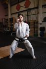 Sportive Man practicing karate in fitness studio — Stock Photo