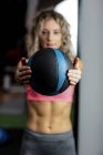 Жінка займається вправами з м'ячем в тренажерному залі — стокове фото