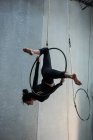 Giovane donna che esegue ginnastica su cerchio in palestra — Foto stock