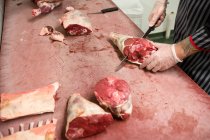 Mittelteil des Schlachters schneidet Schweinekadaver mit Messer in Metzgerei — Stockfoto