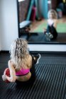 Rear view of woman working out in gym — Stock Photo