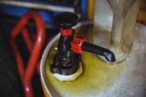 Close-up of valve of oil gallon in industrial workshop — Stock Photo