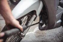 Motorcycle washing with pressure washer at workshop — Stock Photo