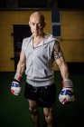 Портрет уверенного тайского боксера, стоящего в фитнес-студии — стоковое фото