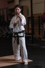 Portrait of man practicing karate in fitness studio — Stock Photo