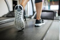 Woman exercising on treadmill at gym — Stock Photo