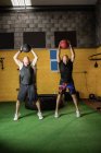 Boxeadores tailandeses haciendo ejercicio con pelotas de fitness en el gimnasio - foto de stock